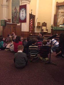 Children sitting on floor in church