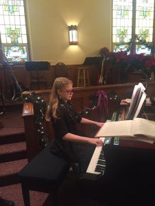 Child playing piano in church