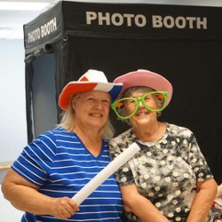 Two women standing in front of photo booth