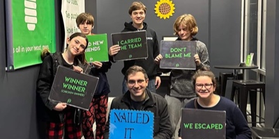 Kids holding signs from escape room