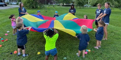 Kids playing with a playground parachute 